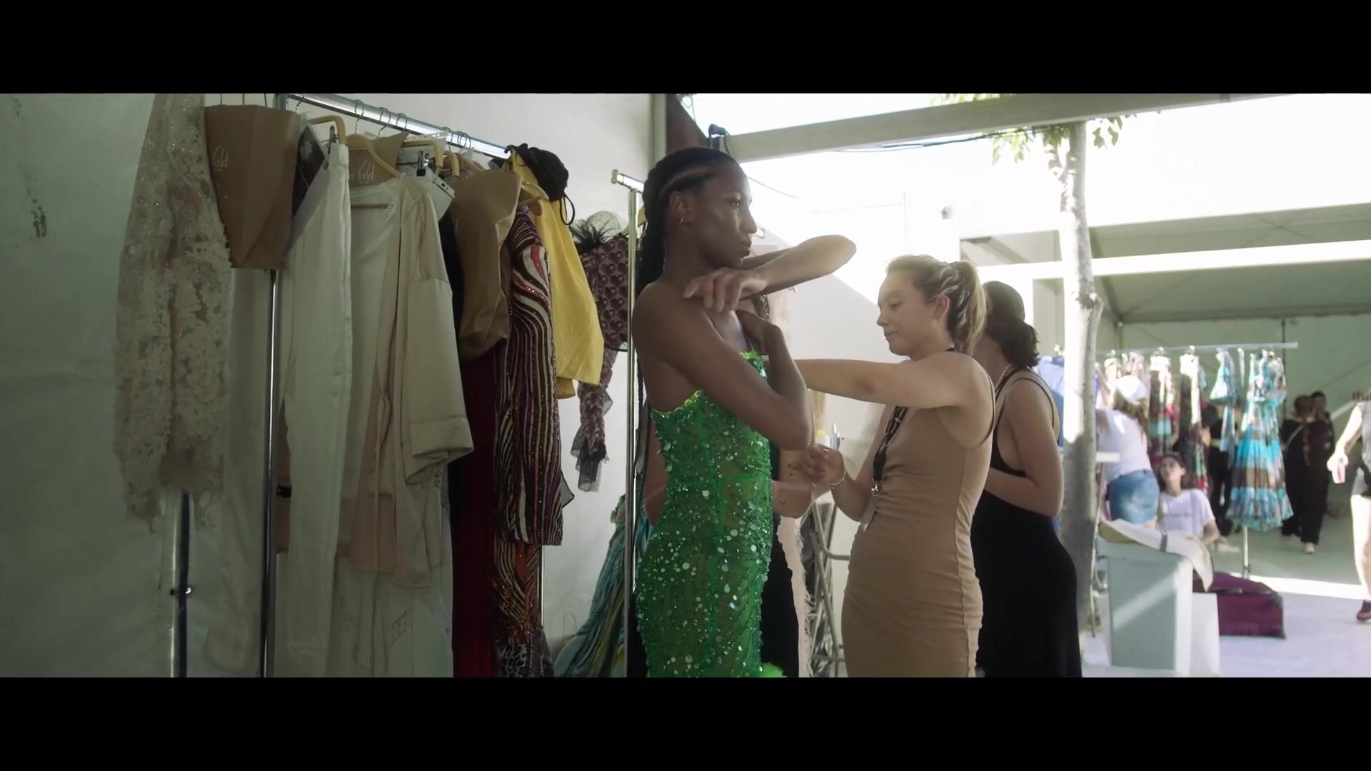 A green dress being adjusted backstage at ADLIB Ibiza